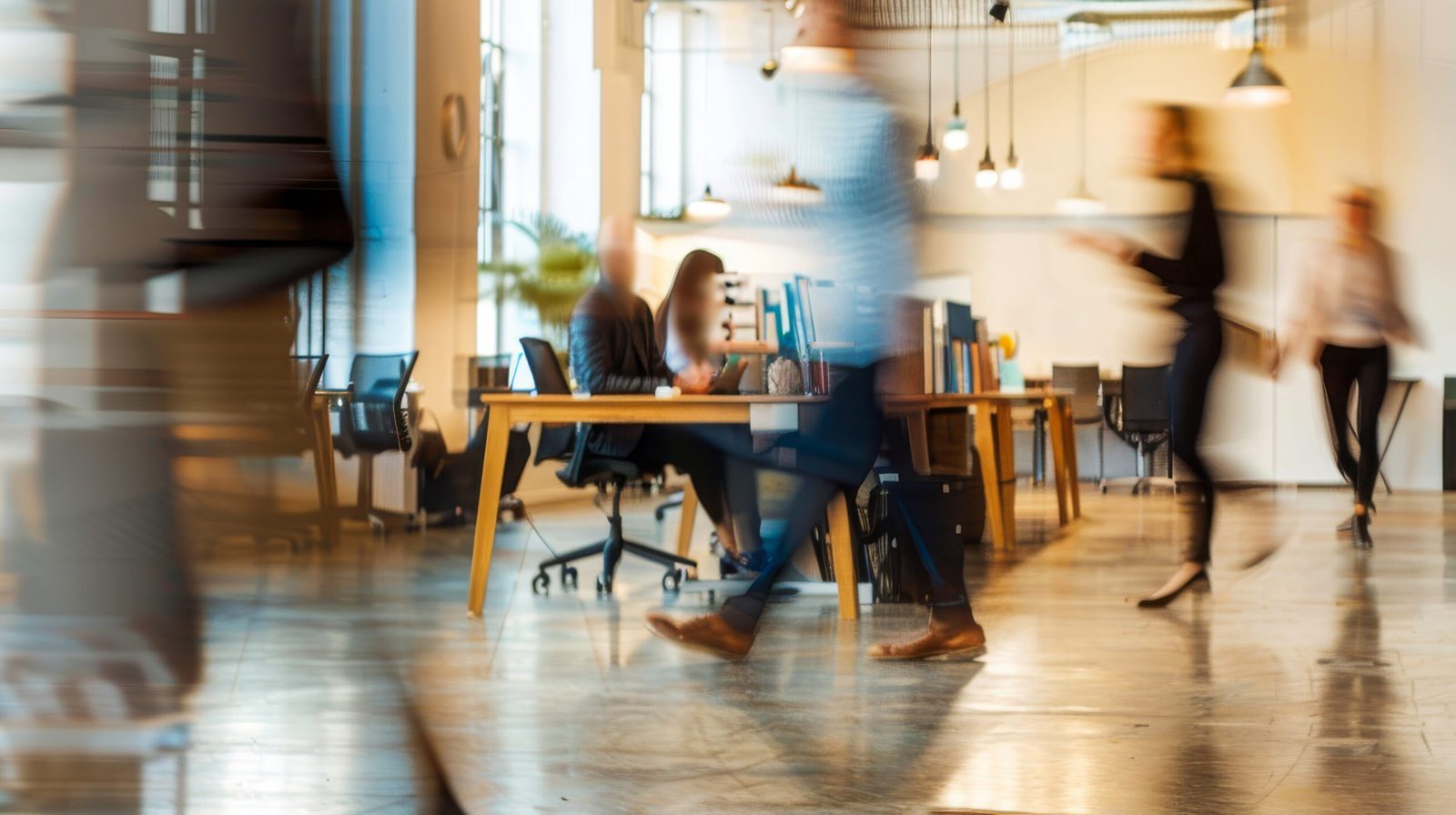 Blurred faces of people in an office environment, symbolising the hidden nature of modern slavery and the need for transparency in business practices.