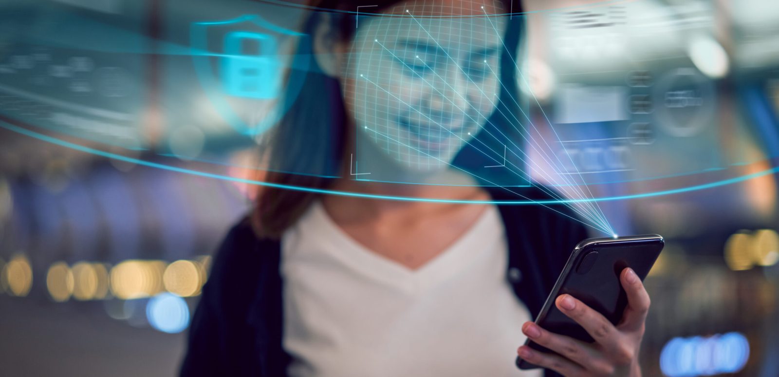 Young woman scanning her face on a mobile phone for age verification
