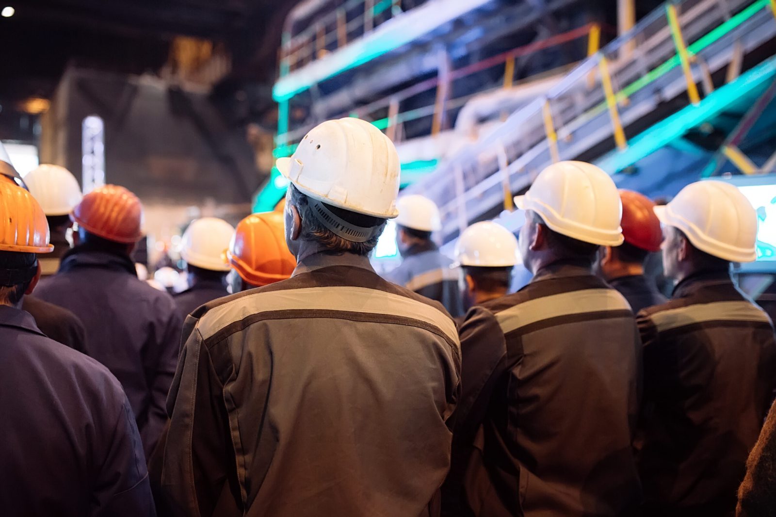 Group of industrial workers wearing hard hats and protective uniforms at a work site, representing trade unions and industrial action under the Employment Rights Act 2025.