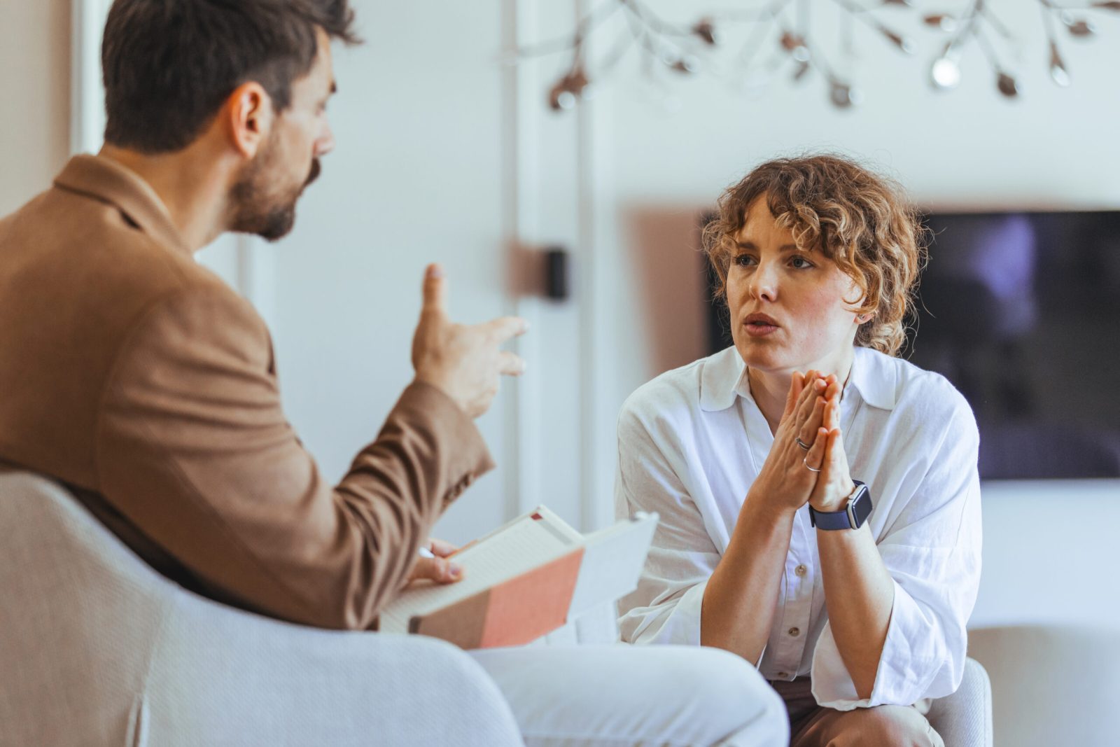 Man and woman in a serious workplace discussion